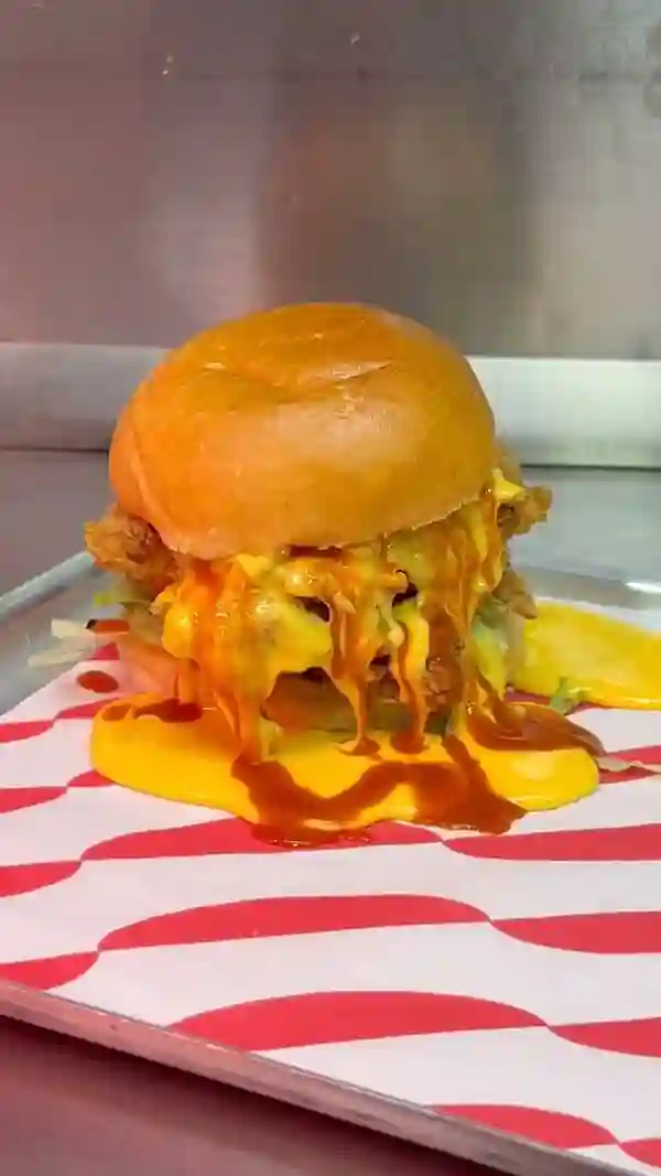 This video showcases Butchies Fried Chicken, a street food establishment in Clapham Common, London.  The video highlights various menu items, including buttermilk fried chicken burgers, halloumi fries, plant-based options, and different sauces. The food is presented in a visually appealing way, emphasizing its textures and colors. The primary focus of the video is to showcase the restaurant's food, emphasizing the deliciousness and variety of their offerings.  Dietary information includes the mention of plant-based options.