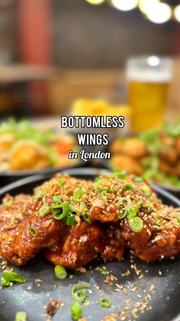 The video showcases a bottomless brunch at Wingmans, featuring various chicken wings (e.g., Korean, buffalo) with fries and drinks. The setting is a restaurant, and the food is presented in appealing ways with various garnishes and sauces. The primary focus is on the different types of wings and the overall experience.