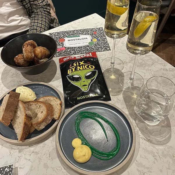 SIX BY NICO & NQ64 – LEEDS 📍[ad/invited]

A very exciting collab with @sixbynicoleeds x @nq64arcadebars for the Nostalgia menu. Including six courses & snacks of food inspired by old school classics! 👾

The food included:
👽 Space “Roast” Raiders Crushed Baby Potato, Pickled Onion, Garlic Emulsion & Fermented Melon Hot Sauce
🧈 Warm Sourdough Served with Smoked Beef Dripping Butter
 
 
1️⃣ Course 1 Blockbuster - Aged Comte, Hazelnut & Serrano Ham ‘Taco’
2️⃣ Course 2 Toadstool - Roasted Maitake, Smoked Celeriac, Cep Gnocchi, Lovage, Truffle & Sherry Cappuccino
3️⃣Course 3 Let’s go camping! - Smoked Pork Sausage, Aged Belly, Red Pepper Romesco, Nasturtium & Almond
4️⃣ Course 4  Fish Fingers - Barbecue Coley, Miso Carrot & Lobster Emulsion, Served with Crispy Fish Finger, Shellfish Bisque & Salted Kumquat
5️⃣ Course 5 Guess Who – inspired by one of their past famous dishes!
6️⃣Course 6 SNOWBALL FIIIIGHT!! - Coconut Parfait, Lime Gel, 55% Chocolate, Yoghurt ‘Snow’

Jed did the cocktail pairing which was v cool and had some great flavoured cocktails! I was staying strong with Dry Jan but I would have loved to try them all. All the cocktails are designed to pair nicely with the dishes. We loved all the food as per and I just love love love the six by nico experience, Sam who served us couldn’t have been nicer 👏🏼  We then took a trip to @nq64arcadebars for more old school vibes with their retro games 🕹️ It was our second time here and I love it to say arcades are not my usual type of thing, its just something totally different with plenty to do! We had some mocktails here too, theyre cocktail menu is fab! 🍹 @joli_app