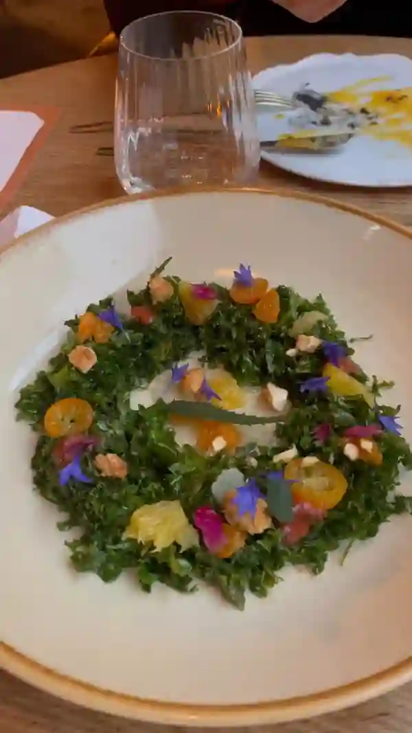 The video showcases a meal at Arros QD restaurant in celebration of World Paella Day.  Various dishes are presented, including different types of paella, a kale salad, bread, and desserts. The presentation focuses on the visual appeal of the food, with close-up shots and overhead shots. No specific dietary information is provided.