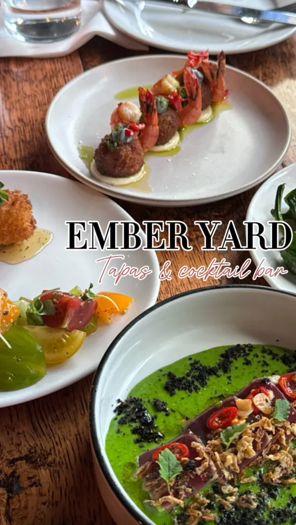 The video showcases a tasting menu at Ember Yard, a tapas and cocktail bar in Soho, London.  The food includes padron peppers, olives, pan-fried prawns with black garlic and prawn croquettes, yellowfin tuna, Iberian beef, grilled asparagus, and a coffee cheesecake.  The presentation is visually appealing, with each dish artfully arranged on simple, white plates.  The video emphasizes the deliciousness of the food and the quality of the cocktails.