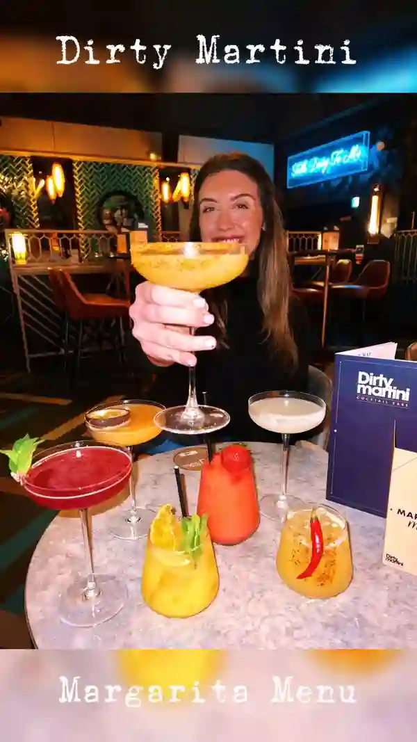 The video showcases a night out at the Dirty Martini bar, highlighting their limited-edition margarita menu. It features various margarita cocktails, including classic, mango, frozen strawberry, passion fruit, skinny, spicy, and a non-alcoholic cherry and bubblegum option. The cocktails are presented in attractive glassware with garnishes like mint, orange slices, and chili peppers.  The video emphasizes the vibrant atmosphere of the bar, with shots of neon signs, lighting, and the overall ambiance. The main focus is on the cocktails and the fun, social aspect of enjoying them at Dirty Martini.