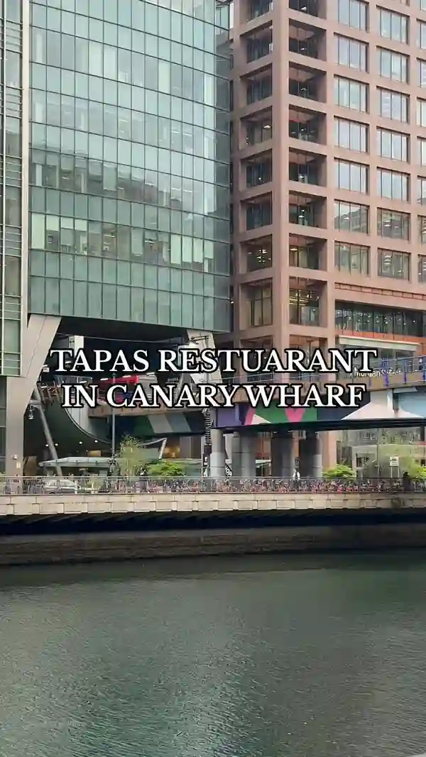 This video showcases Aesthetic Tapas Terrace Restaurant in Canary Wharf, London. It highlights the restaurant's ambiance, featuring a waterfall, outdoor terrace with heat lamps, and stylish interior.  The food presented includes various tapas-style dishes such as small sandwiches with different fillings (meat, tomato-based), cheese selections with accompaniments, cured ham, and a sandwich with pesto. The drinks shown are Prosecco, Aperol Spritz, and cocktails. The video focuses on the aesthetically pleasing aspects of the food, drinks, and venue, emphasizing the overall dining experience.