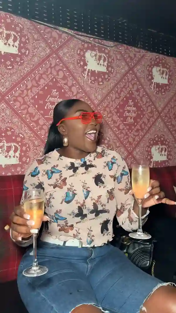 This video showcases a 90-minute bottomless brunch event at The Cocktail Club.  It features various cocktails (including a passionfruit-based one and champagne), and a brunch meal (with rice and chili is shown). The video highlights the energetic atmosphere, drag queen performances, pop-culture bingo game, and overall party vibe. Multiple people, both drag queens and the attendees, are drinking cocktails and enjoying the event. The food is partially shown; its presentation is not a main focus. 