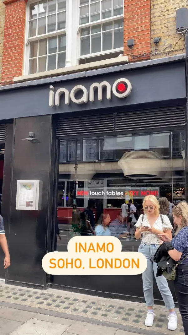 The video showcases Inamo restaurant in Soho, London.  It highlights the interactive touch screen tables used for ordering food and playing games.  Various dishes are shown, including sushi (butterfly roll, other maki), gyoza with mango salsa, Sichuan chicken, sweet and sour chicken, noodles, and chicken karaage. The presentation focuses on the modern and interactive setting of the restaurant, showcasing the appealing visuals of the food. No specific dietary information is provided.