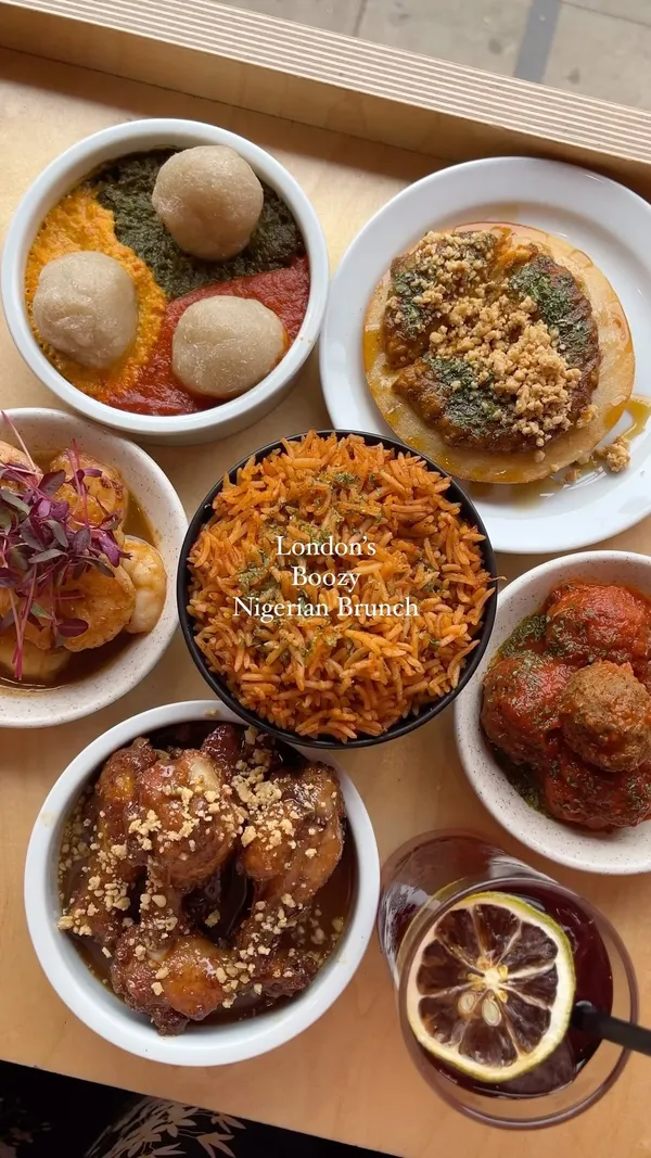The video showcases a Nigerian brunch at Chuku's in London. It features various dishes including honey suya prawns, caramel kuli kuli wings, suya meatballs, an egusi bowl with cassava dumplings and stews, jollof rice, and sinasir with miyan taushe (rice pancakes with peanut and pumpkin stew). The drinks shown are a dark-colored, likely boozy, beverage. The presentation is visually appealing, with close-up shots emphasizing the food's textures and colors. Dietary information indicates the availability of meat, vegetarian, gluten-free, and vegan options.