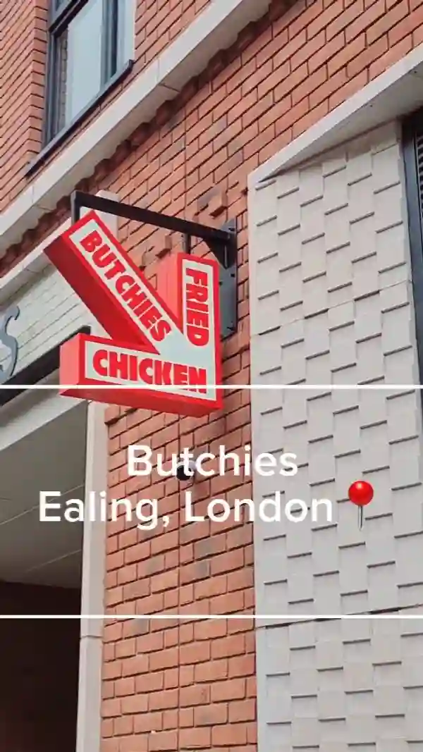 This video showcases Butchies, a fried chicken restaurant in Ealing, London. It features shots of the restaurant's exterior and interior, menu boards displaying various chicken burgers, fries, and milkshakes. The video highlights two main meals: the Cheesy Rider and the OG, both featuring buttermilk fried chicken. It shows a vanilla milkshake and chicken bites. The food items are shown in both close-up shots and while being eaten. The restaurant's interior and kitchen are also shown.  Halal certification is mentioned. 