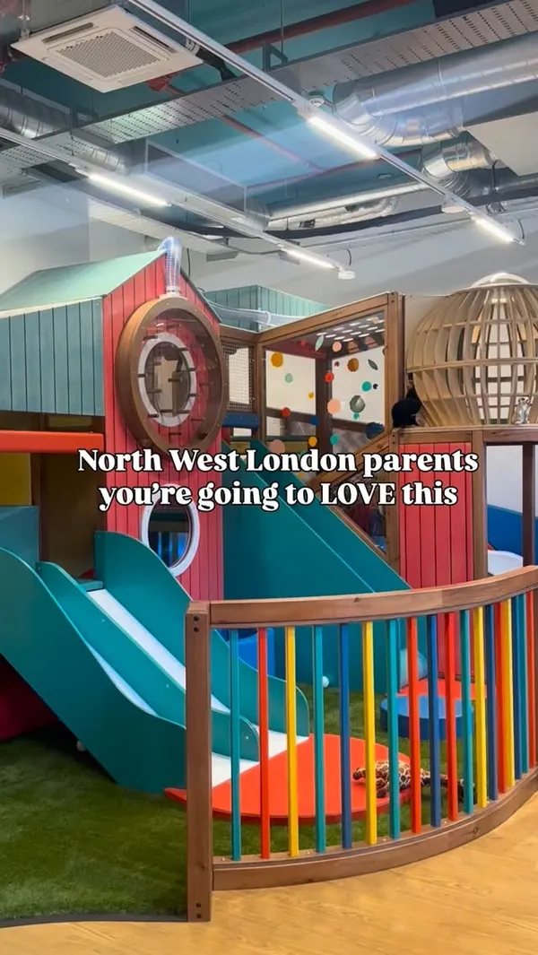 A video showcasing a new children's play cafe, 'Macaroni Penguin Club,' in Wembley Park, London. The video is a montage of various clips showing young children enjoying the different play areas, including slides, a climbing wall, a sensory light table, a toy market, and a train set. The main focus is on the variety of activities available for children aged 6 and under within a modern, colourful, and well-equipped indoor play space.
