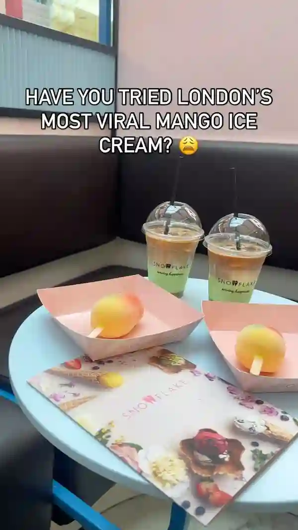 The video showcases Snowflake Gelato, a cafe in the Trafford Centre, Manchester. It highlights the mango ice cream, presented as a popsicle-shaped treat with a white chocolate shell, and the iced pistachio latte. The video focuses on taste testing and sharing the positive experience. No dietary information is explicitly given.