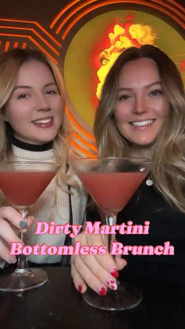 The video showcases a bottomless brunch at the Dirty Martini bar in Birmingham.  It highlights various food items including nachos, cheeseburger sliders, battered fish sliders, chicken skewers with satay sauce, and vegan arancini.  The drinks featured are Pornstar Martinis, Espresso Martinis, Strawberry Kiss, Blood Orange and Vanilla Martinis, Gin & Tonics, Prosecco, and Staropramen. The food and drinks are presented on tiered platters and in elegant glassware. Dietary information mentions vegan options. The primary focus is on the food and drink offerings, along with the atmosphere of the bar.