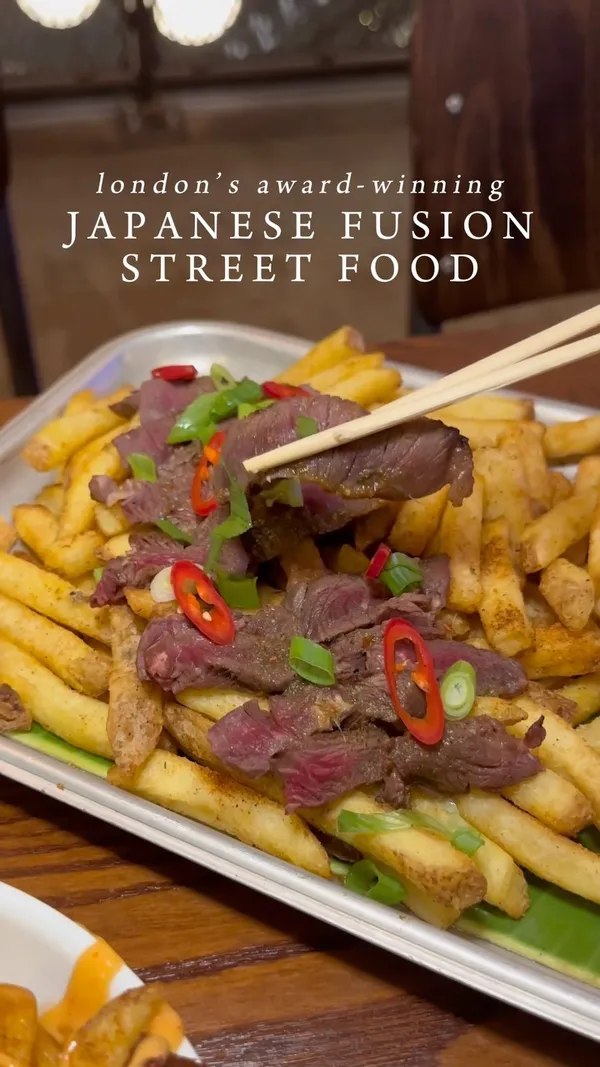 The video showcases Inamo Sukoshi, a Japanese fusion street food restaurant in London's Market Halls Oxford Street. It highlights various dishes including duck fries with cheese and sweet sauce, steak and fries with cheese sauce, and sushi rolls. The food is presented on stylish trays and plates, with close-up shots emphasizing textures and colors. No specific dietary information is provided. The main focus is on showcasing the restaurant's appealing food offerings.