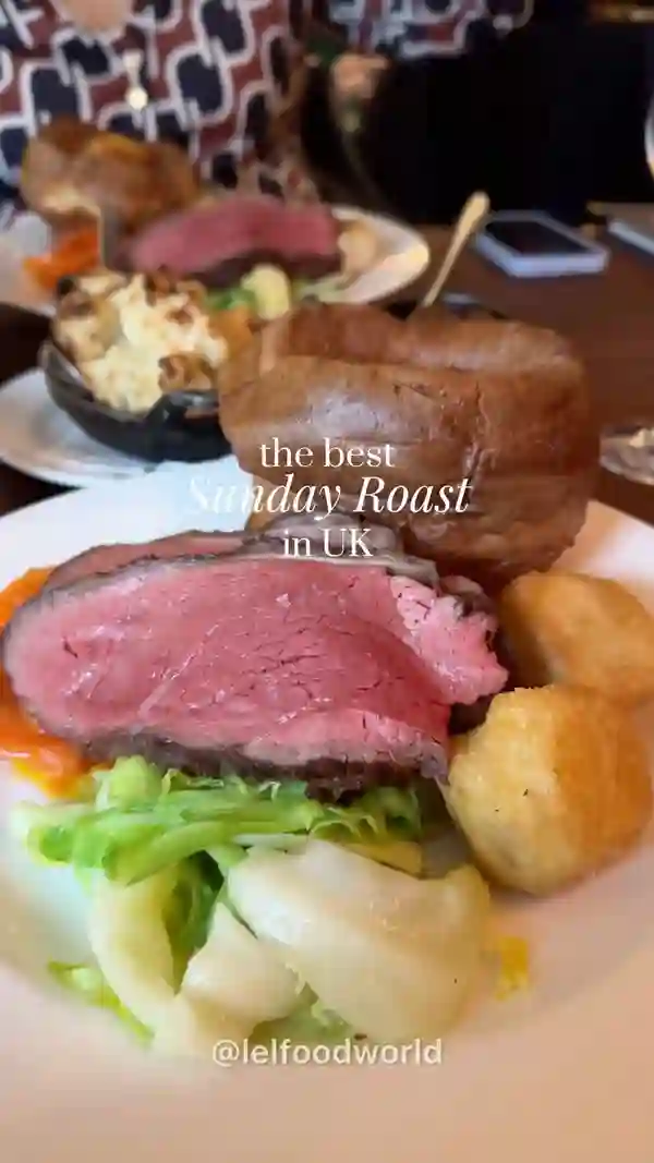 The video showcases Hawksmoor restaurant's Sunday roast. It features various dishes, including roast beef with Yorkshire puddings, roasted potatoes, cauliflower cheese, and a selection of side vegetables. The setting is a high-end restaurant with a sophisticated ambiance. The food presentation is visually appealing, emphasizing high quality ingredients and elegant plating.  The video focuses on the meal itself, highlighting the attractive presentation and the overall dining experience.