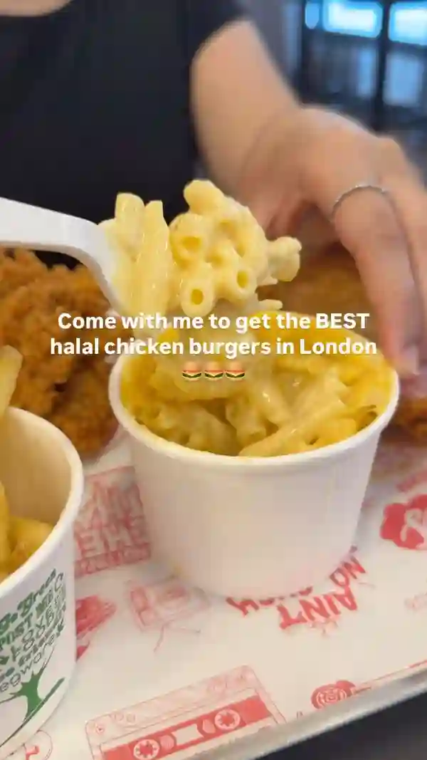 The video showcases Butchies London, a halal chicken burger restaurant. The setting is the restaurant itself. Food items shown include the Cheesy Rider Burger, The Original burger, mac and cheese, fried buttermilk chicken tenders, and fries. The presentation is appealing, with close-up shots highlighting the juicy burgers and crispy chicken.  The main focus is on the food items and the positive experience of eating them.