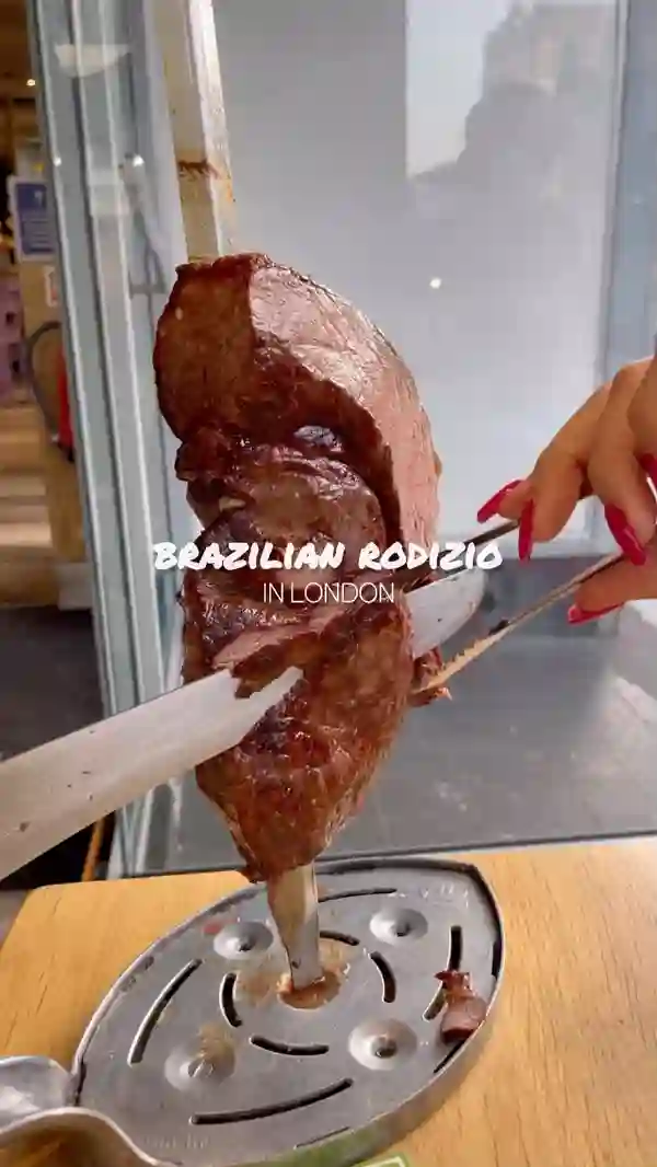 The video showcases Preto Restaurant, a Brazilian Rodizio in London. It highlights the unlimited meat selection (various cuts of grilled meats), the salad bar with various options like rice, beans, and different salads, and a selection of desserts. The presentation focuses on the appealing visuals of the food, emphasizing the variety and abundance. Dietary information is not explicitly given, but it is clear that there are meat and vegetarian options. The primary focus is a meal showcase, highlighting the food and restaurant atmosphere.