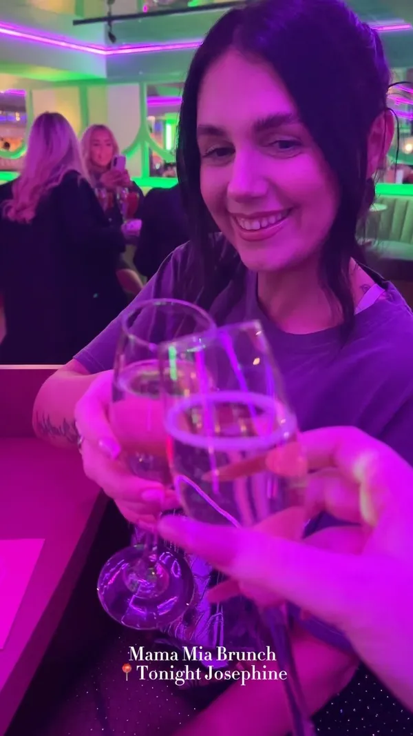 This video showcases a Mama Mia Brunch event at Tonight Josephine, a bar in Liverpool. It features various cocktails (Porn Star Spritz, London Lady, Aperol Spritz), brunch food (burgers and fries), and live musical performances by drag queens. The venue's vibrant pink and purple lighting and decor are highlighted throughout the video.