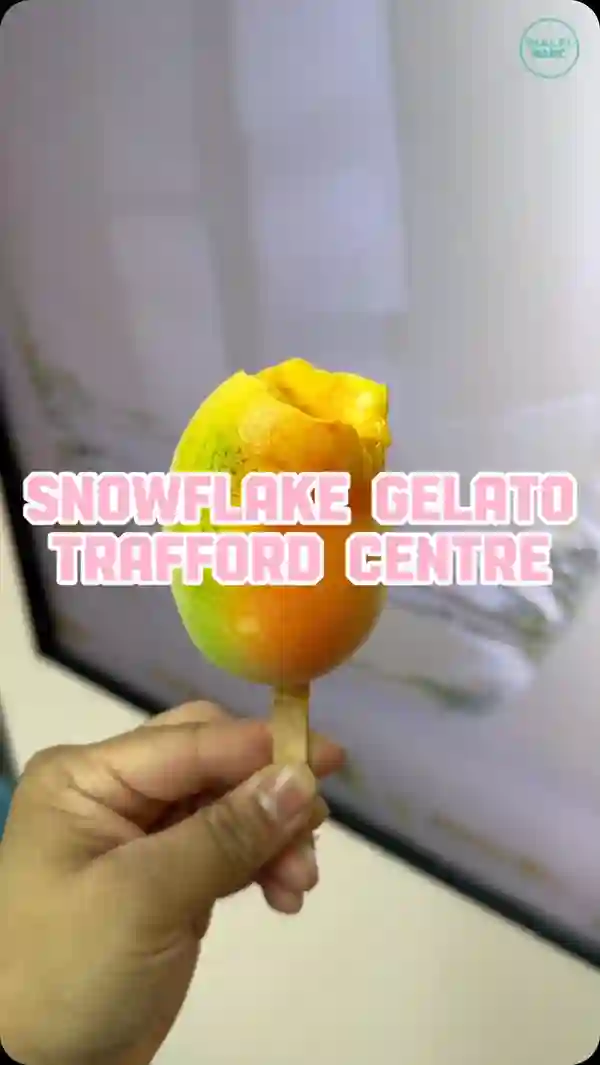 The video showcases Snowflake Gelato at the Trafford Centre in Manchester. It features a vibrant snow mango ice cream, presented in a visually appealing manner. The ice cream is shown being scooped from a container and also being eaten by the influencer.  The video also includes shots of the store and the overall ambiance. The primary focus is on highlighting the product's unique appearance and texture, as well as the location where it can be purchased. No specific dietary information is explicitly stated.