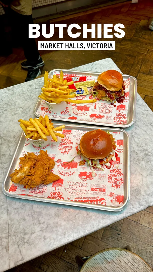 The video showcases Butchie's Buttermilk Fried Chicken restaurant in Victoria, London. It features two meals: one with a buffalo chicken burger, fries, and dipping sauces; and another with buttermilk fried chicken tenders, fries, and dipping sauces.  The burgers are presented as double-stacked with lettuce, sauce, and additional fried chicken. The chicken is golden brown and crispy. The fries are standard cut and golden. The overall presentation is appetizing and clearly highlights the food's visual appeal. The video mentions Halal-certified meat sourcing and separate preparation of Halal and non-Halal foods. The primary focus is on the visual showcase of the food items, with a short mention of location and Halal certification.