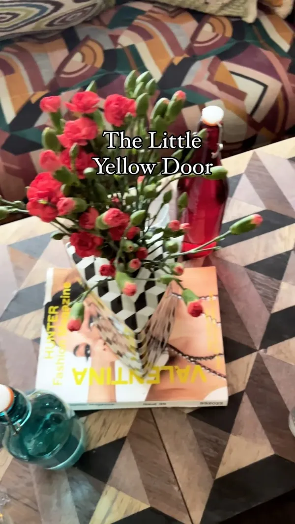 The video showcases The Little Yellow Door, a restaurant in Notting Hill, London.  It features various food items including mezze dips with pitta bread and crudités, panko-fried chicken with aioli, lamb, feta, and harissa sausage rolls, sweetcorn fritters with lemongrass aioli, a truffle cheeseburger with fries, zucchini fries with Aleppo chilli, and a blueberry pie ice cream sundae. The food is presented in a visually appealing manner, on various plates and wooden boards. No specific dietary information is given. The primary focus is a meal showcase.
