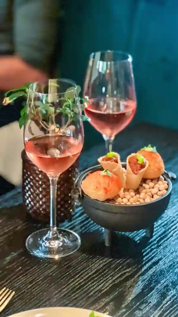 The video showcases an eight-course tapas experience followed by bottomless paella at Arros QD restaurant.  Various dishes are presented, including paella, ceviche, desserts, and cocktails. The food is displayed in a visually appealing manner, emphasizing the vibrant colors and textures. The video focuses on the abundance and variety of food offered during the event. No specific dietary information is provided.