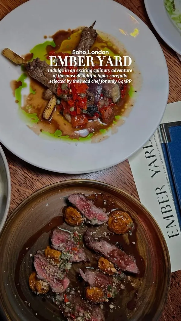 This video showcases Ember Yard, a tapas restaurant in Soho, London.  The video highlights various tapas dishes, including tuna, Padron peppers, asparagus with a sauce, and beef skewers.  A dessert with raspberries and ice cream is also featured. The presentation emphasizes close-up shots of each dish, showcasing the visual appeal and texture. Two cocktails are also shown. The main focus is showcasing the food and the tasting menu deal at the restaurant.