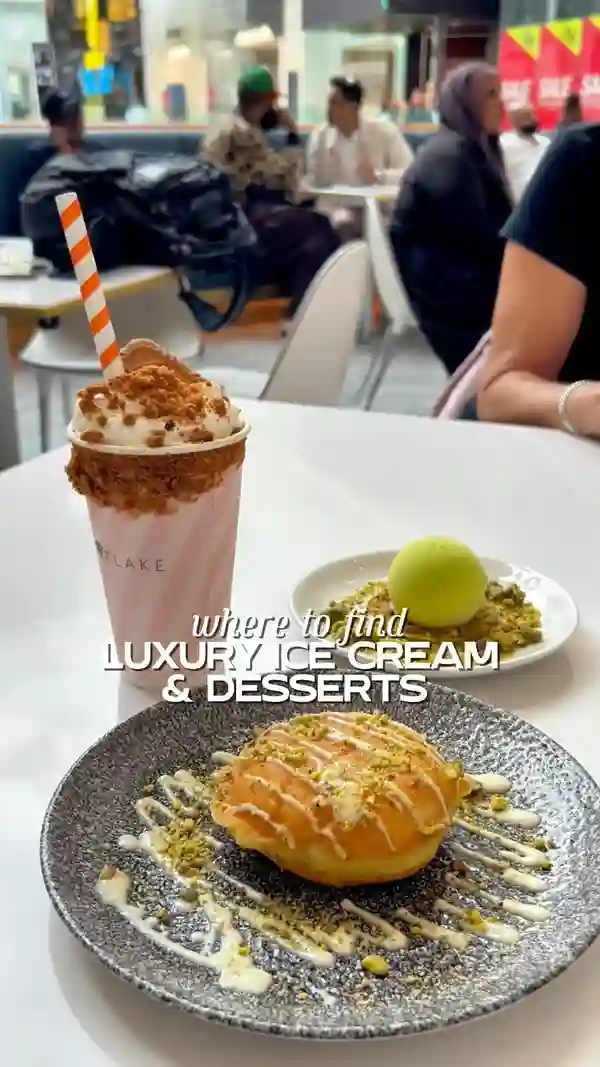 The video showcases Snowflake Gelato, a cafe located in Westfield London. It features various ice cream-based desserts and drinks, including ice cream cones, a pistachio-flavored ice cream tennis ball, a biscoff milkshake, pistachio and hazelnut ice cream baskets, a pistachio-filled donut with white chocolate sauce, and a pistachio-flavored iced latte. The presentation emphasizes the vibrant colors and visually appealing nature of the desserts and drinks. No dietary information is provided. The main focus is on showcasing the different food and drink items.