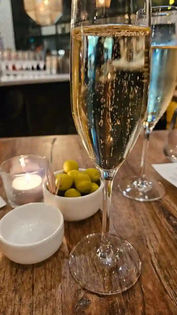 The video showcases a wine tasting experience at Iberica Restaurants in London, featuring wines from Sabaté i Coca.  Each of the four wines (a sparkling white, a rosé, and two reds) is paired with a small dish from the restaurant's deli counter. These pairings include asparagus and cheese toast, croquettes, and a savory spoonful of aubergine based dish.  The video highlights the restaurant's ambiance, wine selection, and food presentation. No specific dietary information is provided.