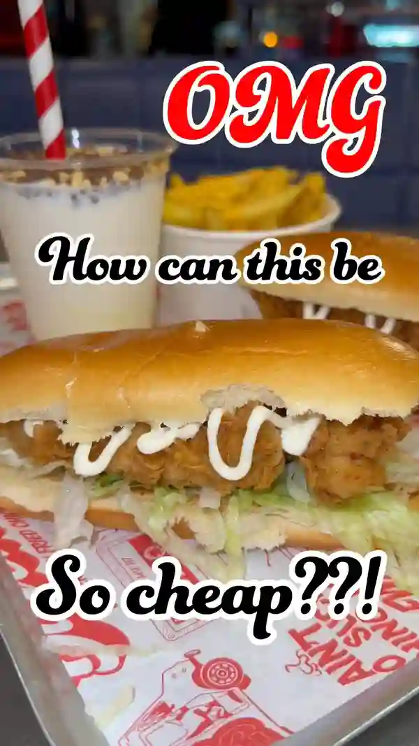 The video showcases Butchies' Chicken Dawg, a buttermilk chicken tender, lettuce, and mayo sandwich in a brioche bun, served with fries and a milkshake. The setting is primarily the restaurant's storefront and interior. The food is presented in a visually appealing manner using overhead shots and close-ups, highlighting its textures and components.