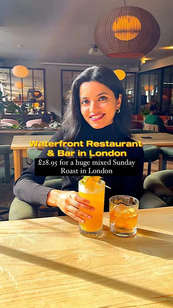 This video showcases Waterfront Bar and Restaurant in Canary Wharf, London.  It highlights their Sunday roast, which is presented as a large mixed platter (£28.95) including beef, pork belly, chicken, Yorkshire puddings and various vegetables.  The video also shows other food items like starters, cocktails and a glimpse of the restaurant's interior and exterior, emphasizing the bright and spacious atmosphere.  The main focus is on promoting the restaurant's food and ambiance.