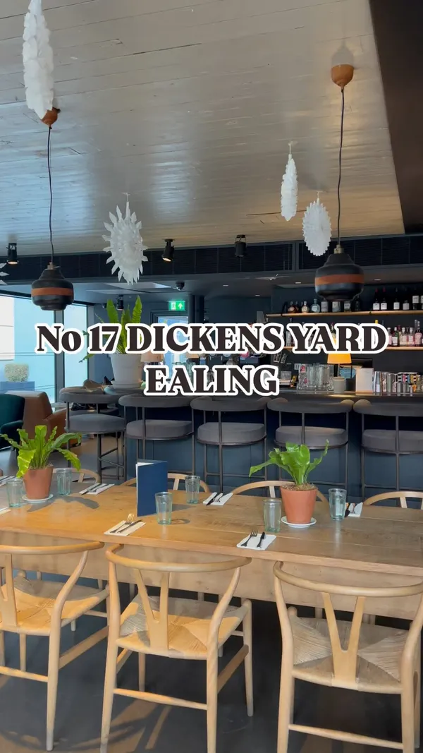 The video showcases a brunch at No.17 Dickens Yard in Ealing, London. It features various brunch items, including a dirty breakfast bagel, eggs benedict, and brioche french toast.  A selection of smoothies is also presented. The food is shown in close-up shots and placed on well-lit tables with a neutral background. The overall aesthetic is modern and clean. Dietary information is not explicitly stated.