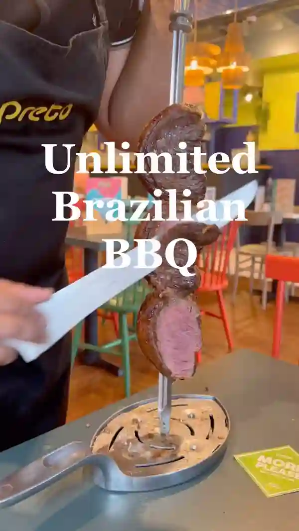 The video showcases Preto Restaurant, a Brazilian BBQ establishment in London. It features various cuts of meat (beef, lamb, pork, chicken, sausages) being served rodizio-style.  The buffet includes salads, various sides (mashed potatoes, fries, stews, beans), and other items.  The video highlights the unlimited meat option and the 'I'm Full' card system. Halal options are available on request. The main focus is on the food and dining experience.