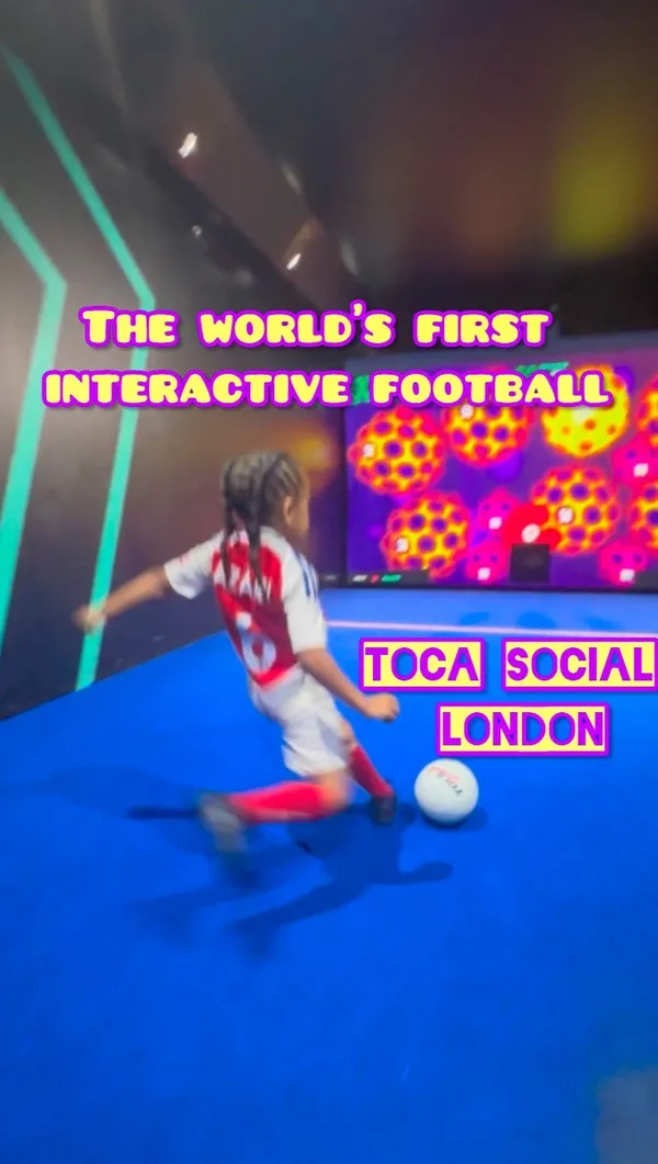 The video showcases TOCA Social, an interactive football and dining experience located at The O2 in London. It features children playing various interactive football games within the venue. The video highlights the venue's immersive gaming environment, world-class food and drink, and the overall fun experience.  Specific food or drink items are not clearly shown.