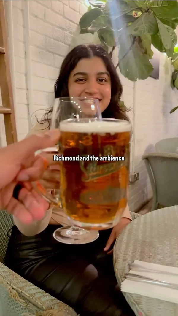 The video documents a couple's Saturday night dinner date at No.1 Duke Street restaurant in Richmond. It features shots of the couple arriving, the restaurant's exterior and interior ambiance, their drinks (beer and wine), a starter of fried calamari with lemon, and main courses including roasted duck with greens and potatoes, and seafood spaghetti. The couple is shown tasting each other's dishes.