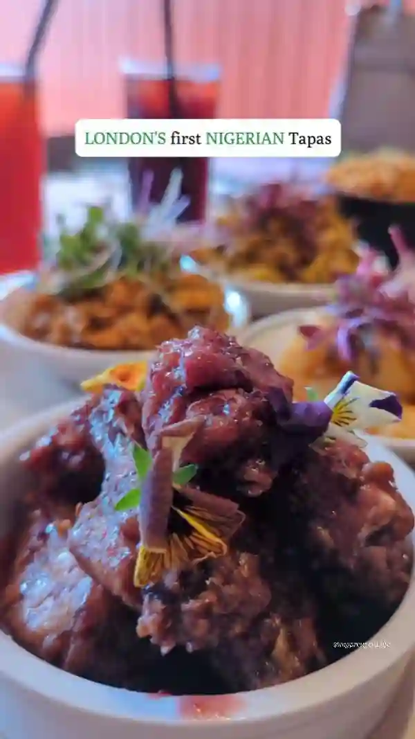 This video showcases Chuku's, a Nigerian tapas restaurant in London. It features various dishes including Jollof quinoa, Egusi bowl, Crispy okra, Banga prawns, Suya prawns, Chicken Ata Din Din, Banga Chicken, Zobo wings, and Chin Chin cheesecake. The food is presented in small, sharing-sized portions, garnished with fresh herbs and edible flowers. The video highlights the restaurant's ambiance and promotes social dining.  No specific dietary information is explicitly provided.