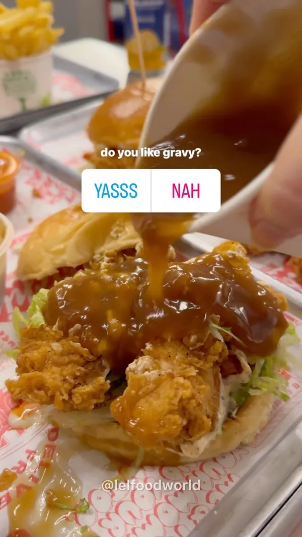 The video showcases Butchies London's new gravy. The setting is a casual restaurant or eatery. It shows fried chicken tenders, burgers, and fries. The presentation is appetizing, highlighting the golden-brown fried chicken and rich brown gravy. No dietary information is explicitly stated. The main focus is on the gravy and how it complements the fried chicken.