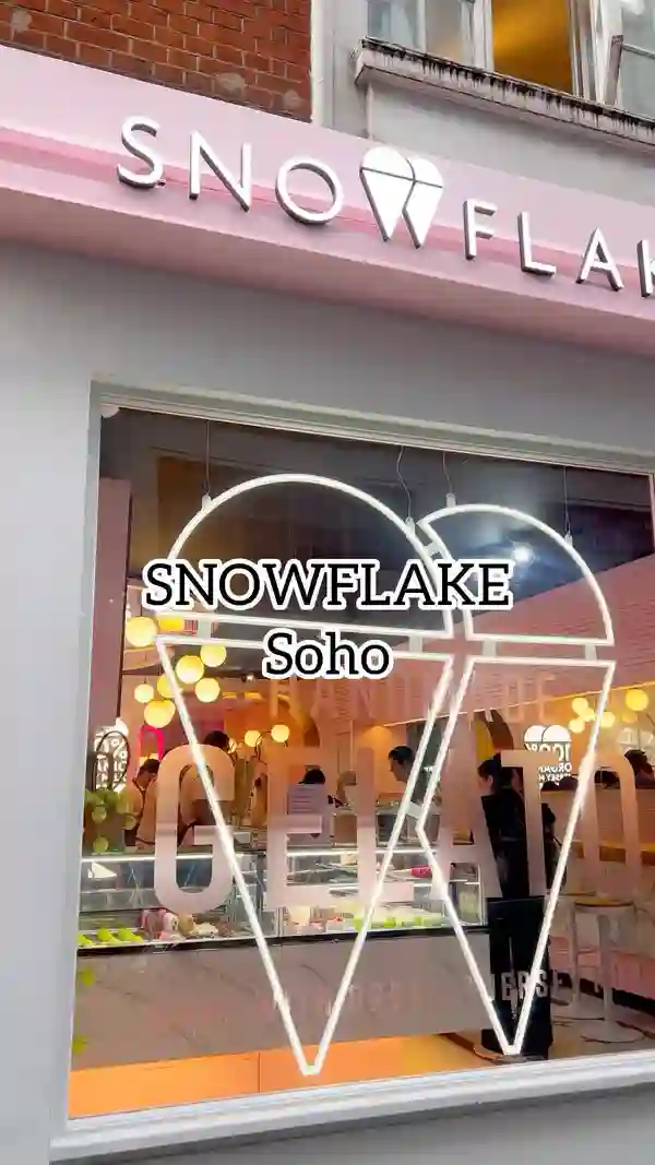 The video showcases Snowflake Gelato in Soho, London. It features various desserts and drinks, including a limited-edition Wimbledon tennis ball dessert, a crepe with Nutella and strawberries, a raspberry bounty gelato basket, a Lotus milk cake, and an iced chocolate drink. The presentation focuses on close-up shots of the food and drinks, highlighting their visual appeal and textures. No specific dietary information is provided.