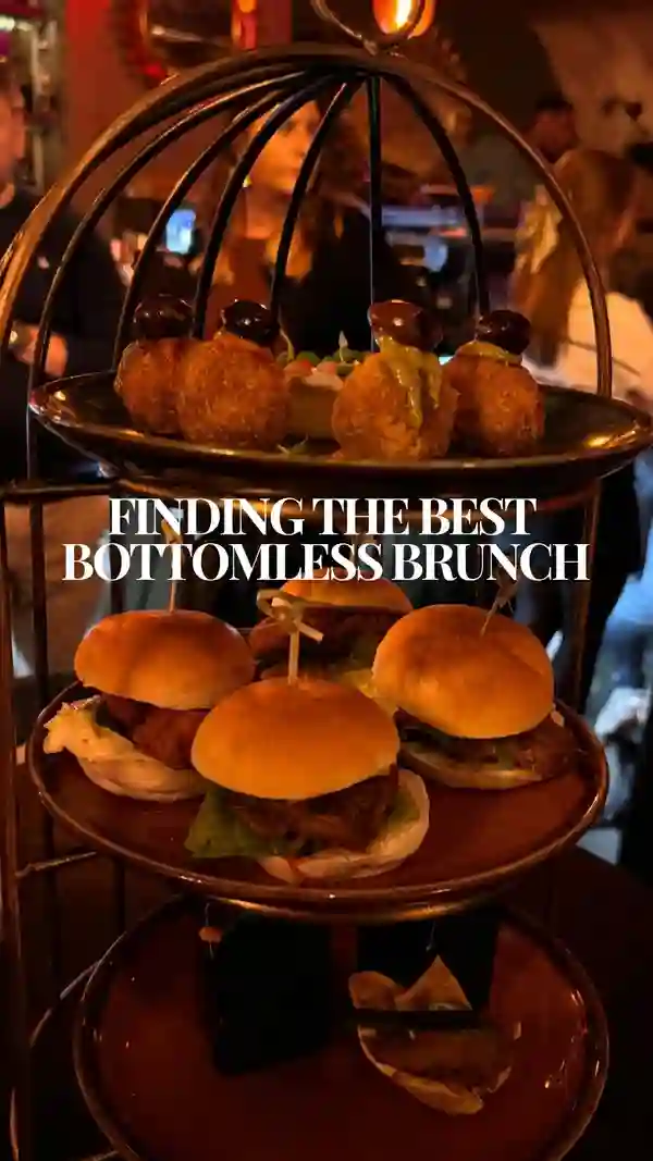 The video showcases a bottomless brunch at Dirty Martini, a bar with multiple UK locations. It features various cocktails (Pornstar martini, Espresso martini, Strawberry kiss martini, Blood orange & vanilla martini), a live saxophonist, and a three-tiered sharing platter with items like barbacoa pulled beef sliders and nduja arancini. The presentation emphasizes vibrant colors and a lively atmosphere.