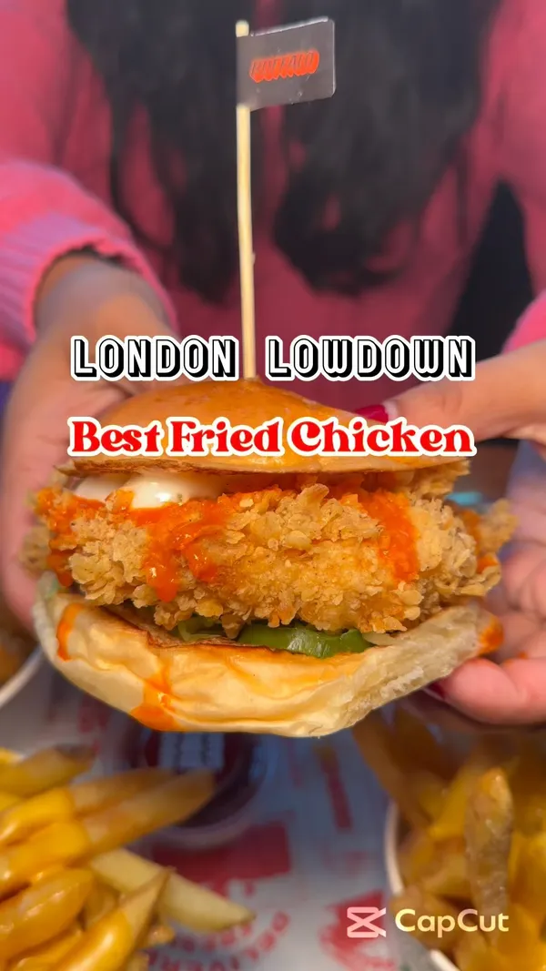 The video showcases Butchies Buttermilk Fried Chicken at Canary Wharf's Cargo Market Hall. It features various food items including a buffalo buttermilk fried chicken sandwich, popcorn chicken, cheese fries, and halloumi fries. The food is presented in close-up shots highlighting its textures and colors, emphasizing its appetizing qualities. No dietary information is explicitly provided. The main focus is on the food, with the influencer's reaction included.