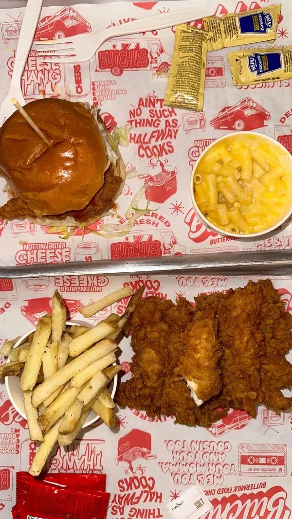This video showcases Butchies Fried Chicken, a restaurant in London. The video features a walkthrough of the restaurant, showing its interior and menu, which includes buttermilk fried chicken, chicken sandwiches, wings, tenders, popcorn chicken, mac and cheese, and various dipping sauces. The food is presented in a visually appealing manner using a variety of angles and close-ups. No dietary information is explicitly stated. The main focus is on the food and its presentation. 