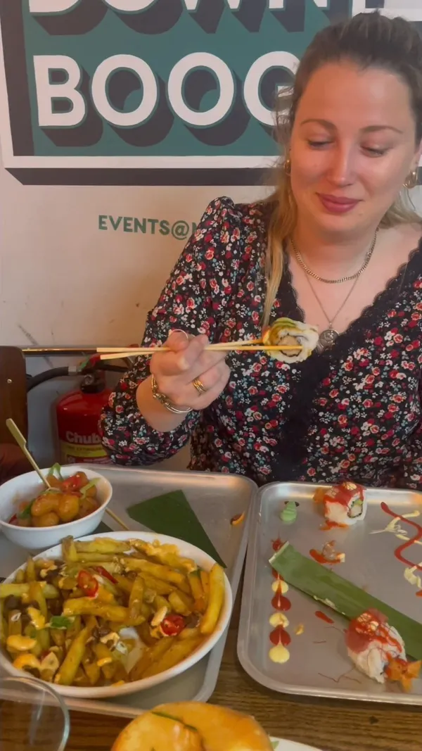 This video showcases Inamo restaurant at Market Halls in Oxford Street, London.  The video highlights various dishes including sushi (Dragon Roll, Samurai Roll), duck fries, karaage burger, bang bang cauliflower, and crispy teriyaki duck pancakes.  The presentation is visually appealing, with careful plating of the sushi and a focus on close-up shots of the food.  Dietary information is not explicitly provided.  The main focus is a meal showcase.