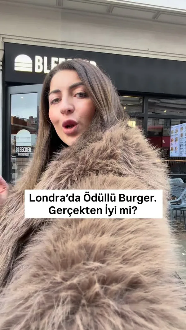This video is a review of the award-winning burger restaurant, Bleecker Burger, in London. It begins with the creator outside the restaurant, posing the question of whether it lives up to its reputation. The video then showcases various food items, including a double cheeseburger and two types of loaded fries. It features shots of the food being prepared in the kitchen, close-ups of the burger, and the creators eating and giving their positive reactions. The video also includes a clear shot of the menu and concludes with the creators summarizing their enjoyable experience.