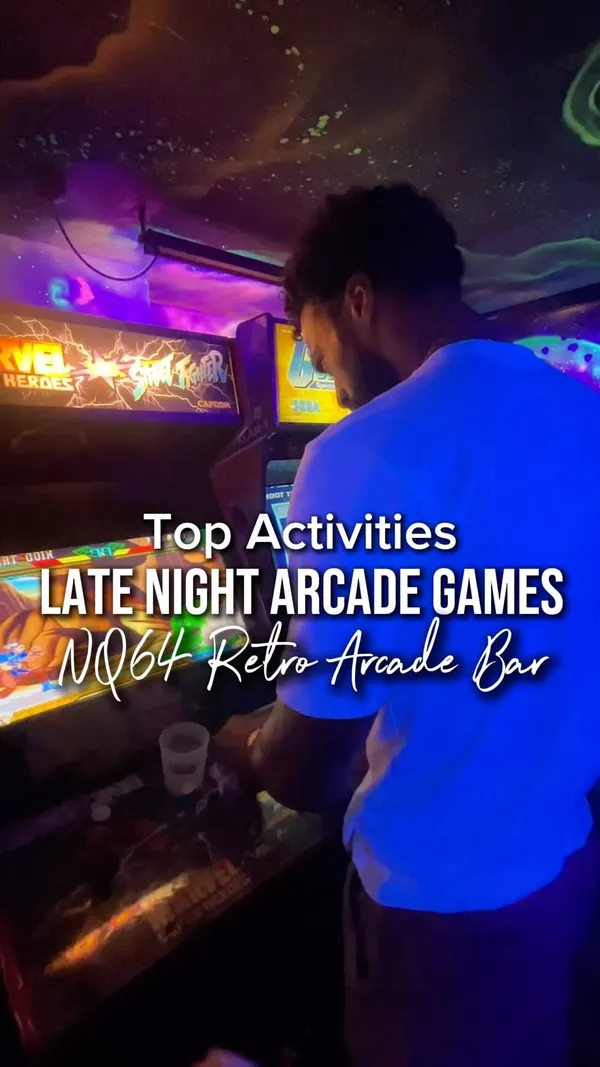 The video showcases NQ64, an arcade bar in London. It features various retro arcade games, cocktails, and a vibrant atmosphere. The video highlights the bar's ambiance, game selection (including Guitar Hero, Tetris, Pac-Man, Mortal Combat, shooting games, and driving games), and cocktail menu. It also mentions the bar's late hours (open until 3 AM) and its Soho and Shoreditch locations.