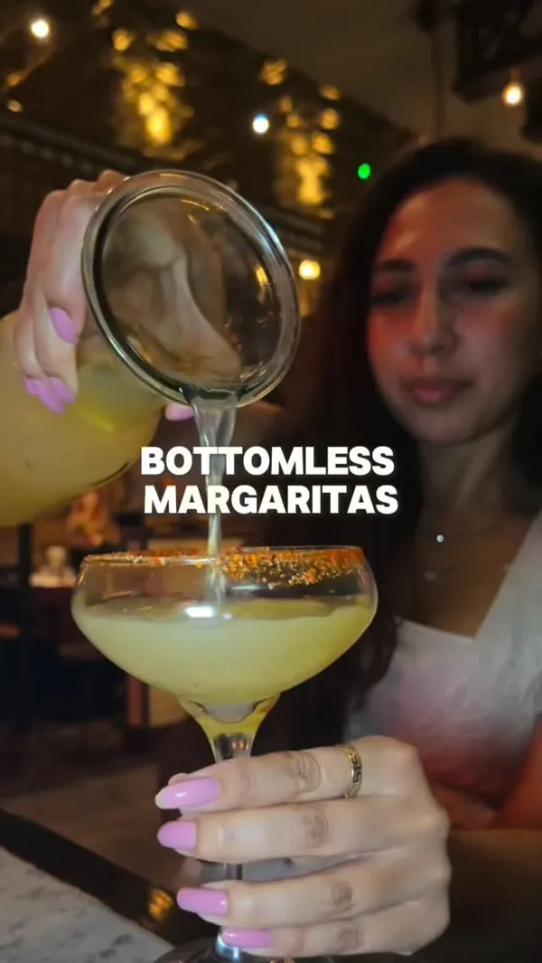 A review of a bottomless margarita and nachos deal at Maxwell's in Covent Garden, featuring the creator trying different margarita flavors and sharing the food.