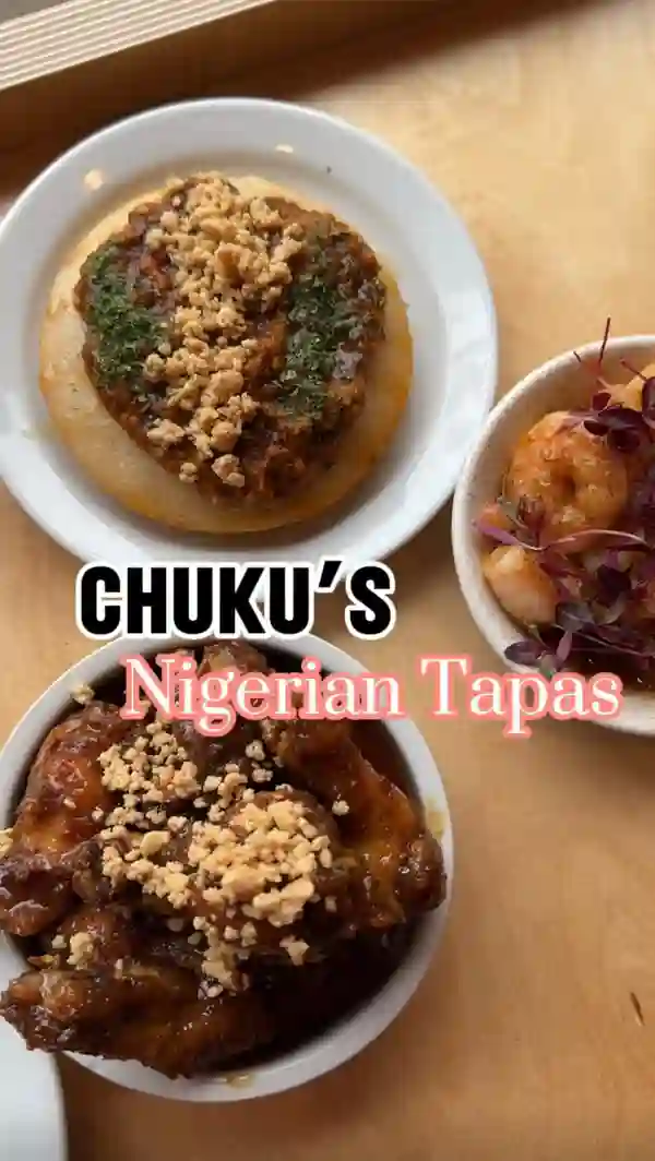 This video showcases a meal for two at Chuku's Nigerian Tapas restaurant in Seven Sisters, London. The restaurant's interior features pink walls and simple lighting. The food includes: egusi soup with fufu, caramel kuli kuli wings, lamb ayamase, jollof rice, honey suya prawns, and sinasir with miyan taushe.  The presentation emphasizes small plates, with vibrant colors and garnishes. The main focus is on a tasting of various dishes and the positive reactions from the two women enjoying their meal.  There's no specific mention of dietary options.