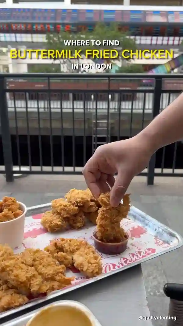 The video showcases a variety of buttermilk fried chicken dishes from Butchies, located at Market Halls, Canary Wharf in London.  The food includes burgers (Cheesy Rider Double Up, Korunch, Chicken Dawg), chicken tenders, wings, popcorn chicken, fries, and various sauces (OG Gravy, Jenny Sauce, BBQ Sauce, melted Red Leicester). Sides such as mac and cheese and coleslaw are also featured.  The presentation is vibrant with close-up shots highlighting the textures and colors of the food.  Halal options and vegetarian options are mentioned. The primary focus is on the food and its presentation, with a clear emphasis on its deliciousness and quality.