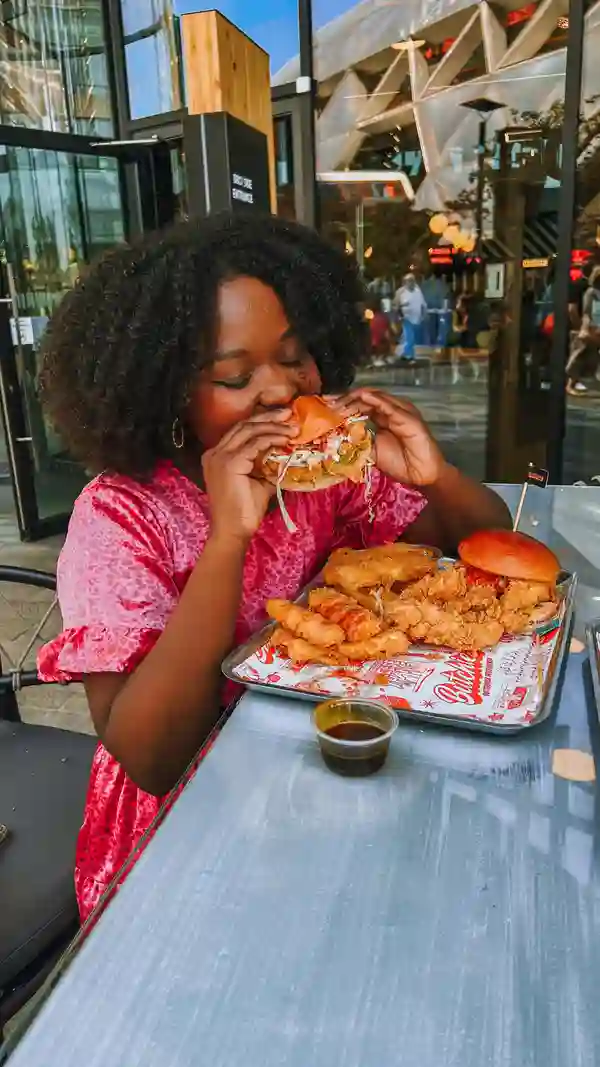 The video showcases a meal from Butchies, a London-based restaurant. It features a close-up of various fried items like chicken tenders, mozzarella sticks, and a burger. The video uses dynamic shots to showcase the food's texture and color. The overall vibe is energetic, highlighting the enjoyment of the food.  No dietary information is explicitly given.