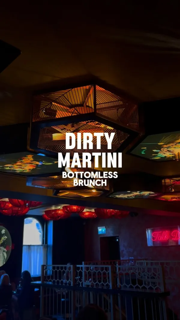 The video showcases a bottomless brunch at Dirty Martini, a bar. It features various food items presented in a birdcage-style tiered stand, including mini burgers, nachos, and what appears to be chicken nuggets. Cocktails shown include Pornstar Martinis, Blood Orange & Vanilla Martinis, and Strawberry Kiss cocktails. The food is presented attractively, with a focus on the cocktails and the overall brunch experience. No specific dietary information is provided.