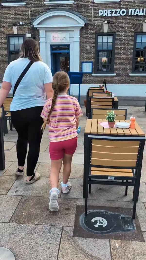 The video promotes a 'Kids Eat Free' subscription offer at the Prezzo Italian restaurant chain. It begins with a mother and daughter walking into the restaurant, followed by shots of the promotional flyer and the kids' menu. The video showcases various dishes, including appetizers like prawns with bread and olives, and a main course of spaghetti bolognese. It captures the family dining experience, with the child colouring and adults enjoying their meals. The interior of the restaurant is also shown to give a sense of the atmosphere.