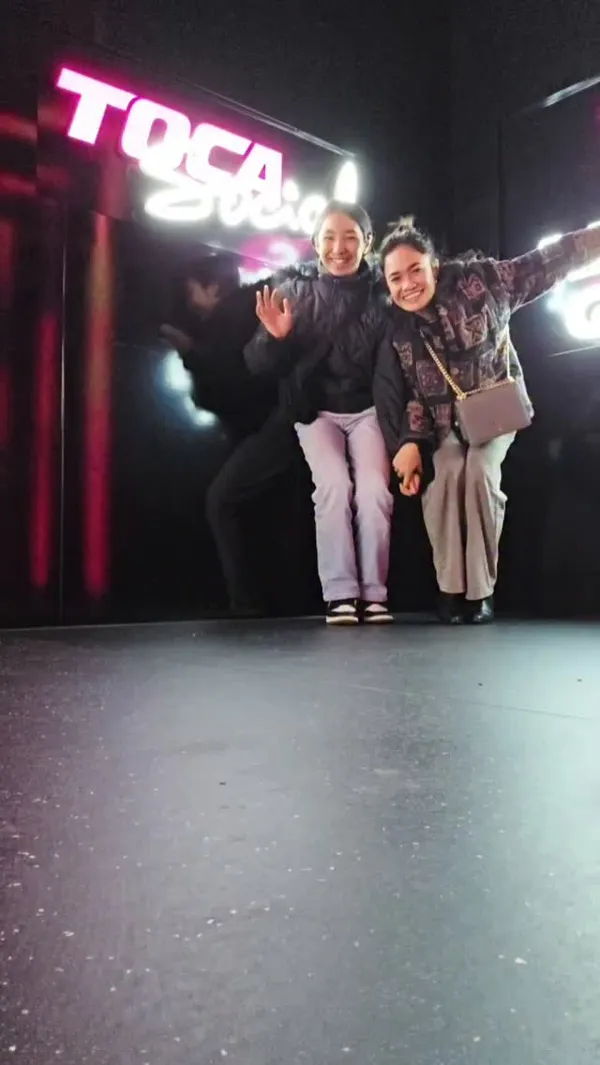 The video showcases a family's visit to Toca Social, an interactive football and dining venue. It begins with shots of the venue's exterior and interior, highlighting the modern, neon-lit decor. The video features the family participating in various interactive football games, playing foosball, and enjoying a meal. The food shown includes burgers with fries, chicken wings, and chicken tenders with fries. Cocktails and mocktails are also featured. The overall atmosphere is portrayed as energetic, fun, and suitable for families and groups.