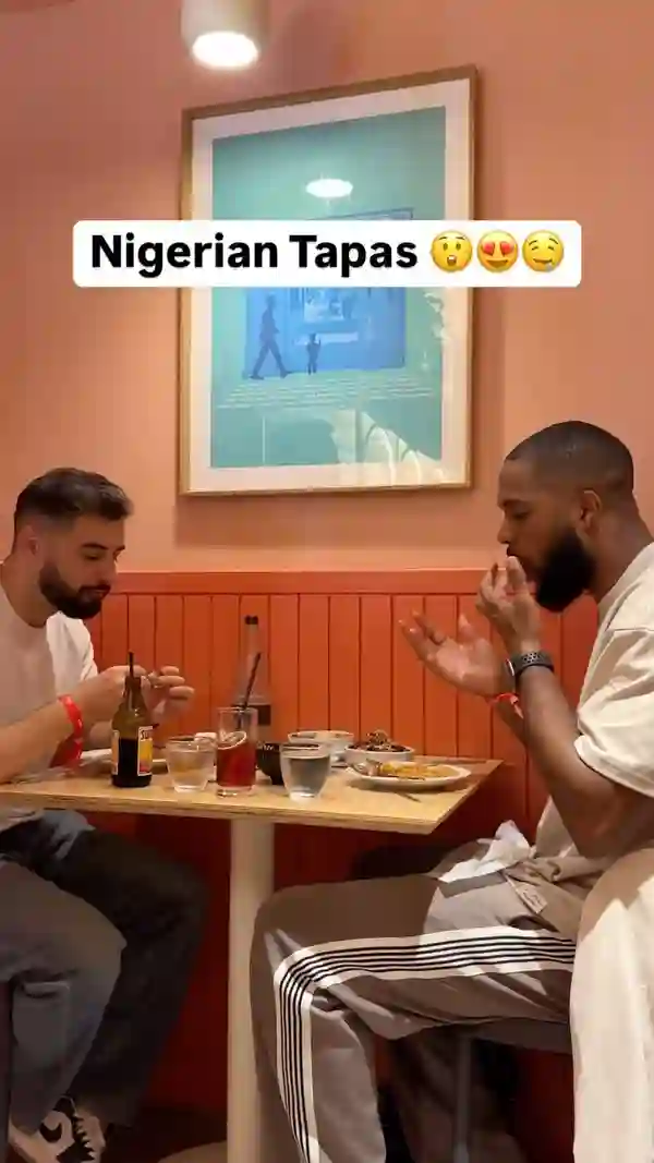 This video showcases Chukus Nigerian Tapas restaurant in Tottenham, London. It features various small plates of Nigerian tapas, including honey suya prawns, caramel kuli kuli wings, egusi bowl, jollof rice, and cassava chips. The food is presented in visually appealing small bowls and plates, with overhead and close-up shots that emphasize color and texture.  The video also shows the restaurant's interior and bar, highlighting Nigerian beers, wines, and cocktails, plus desserts such as chin chin cheesecake and Albi’s plantain waffle. The main focus is to showcase the food, drinks, and unique concept of the restaurant.