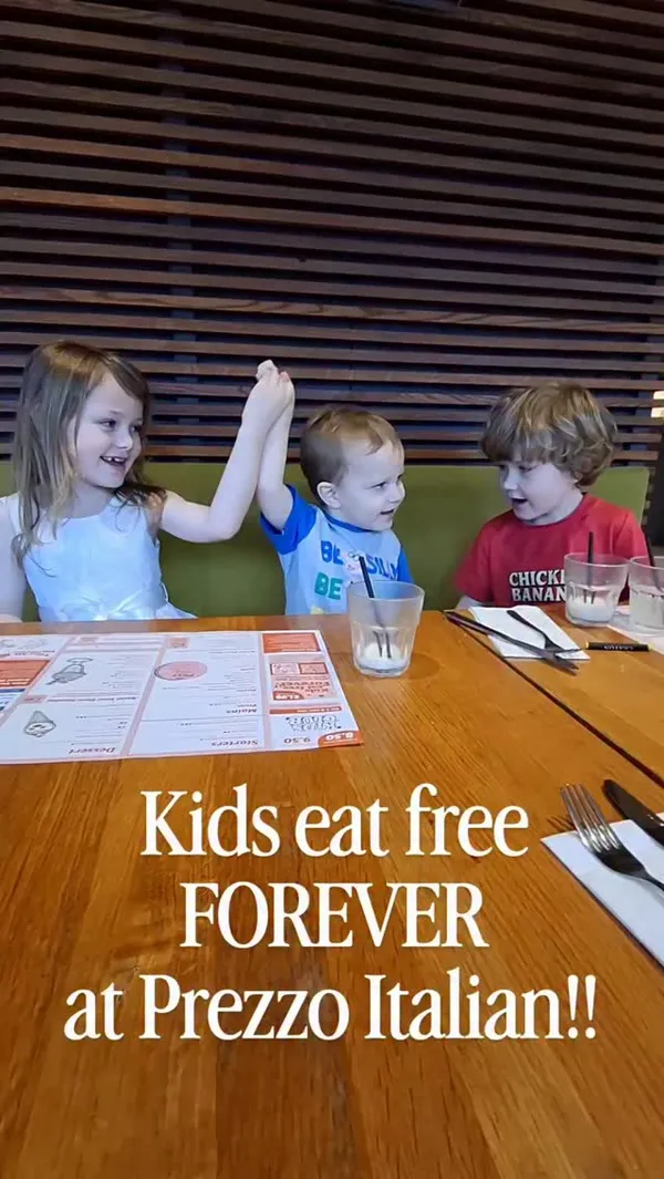 A short montage video showing three young children enjoying a meal at a Prezzo Italian restaurant. The video features clips of the children sitting at a table, looking at the menu, eating a margherita pizza with a side of cucumber, and a bowl of ice cream with whipped cream and sprinkles for dessert. The overall tone is happy and family-friendly.